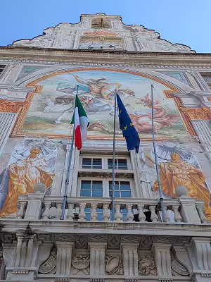 The frescoed facade of Palazzo San Giorgio facing the port of Genoa
