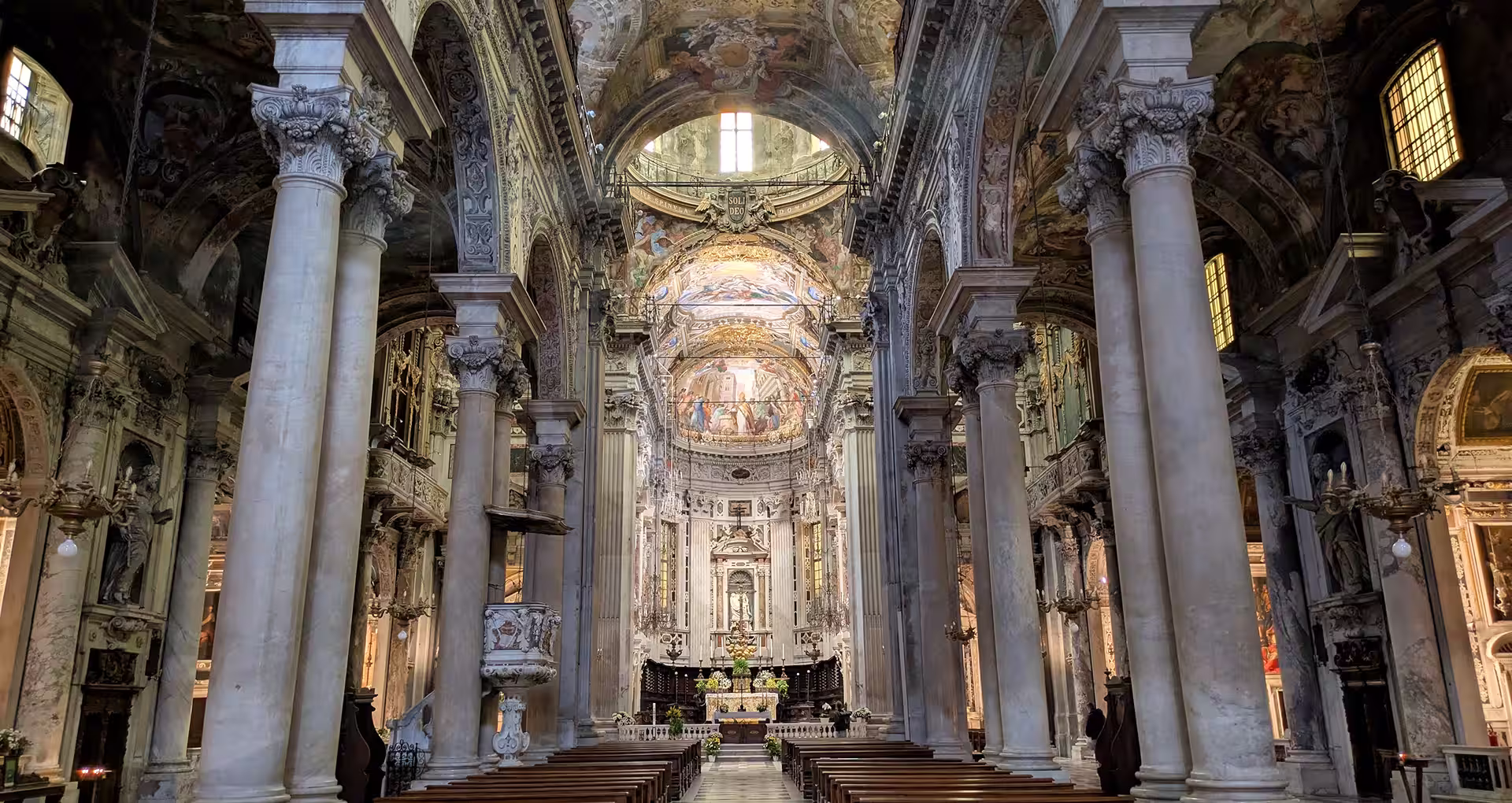 Gilded frescoed nave and marble columns of the San Siro church, things to do in Genoa, Italy